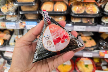 Penang, Malaysia – May 12, 2024: A packaged Salmon Cream Cheese Onigiri displayed at FamilyMart. This Japanese rice ball, wrapped in seaweed, features creamy salmon filling for a quick and tasty snack